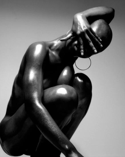 A dancer curled into a sculptural pose